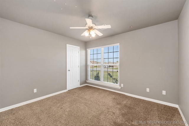 705 SW 20th St, Wagoner, OK 74467 - unfurnished room with baseboards, a ceiling fan, and carpet flooring