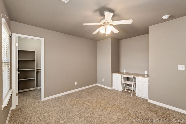 705 SW 20th St, Wagoner, OK 74467 - interior space featuring light carpet, built in study area, baseboards, and ceiling fan