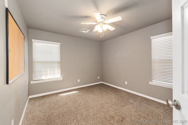 705 SW 20th St, Wagoner, OK 74467 - unfurnished room with carpet flooring, visible vents, baseboards, and a ceiling fan