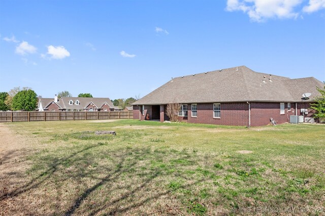 705 SW 20th St, Wagoner, OK 74467 - view of yard featuring central AC and fence