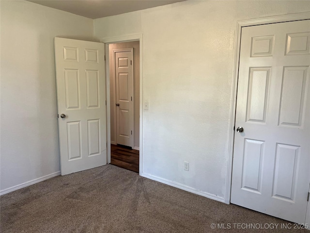 28494 E 139th St S, Coweta, OK 74429 - unfurnished bedroom featuring baseboards and dark carpet