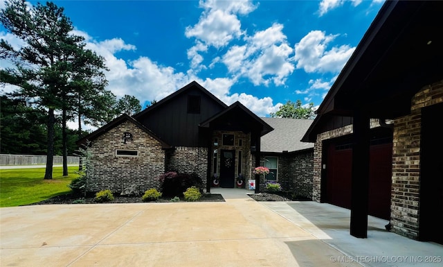 16265 N 573, Tahlequah, OK 74464 - view of front of house with concrete driveway, board and batten siding, and brick siding
