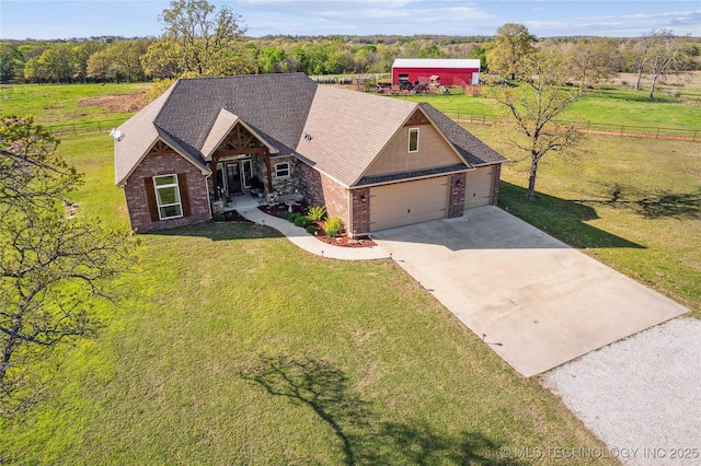 369102 E 960 Road, Road, OK 74833 - craftsman house with fence, concrete driveway, brick siding, a front lawn, and roof with shingles