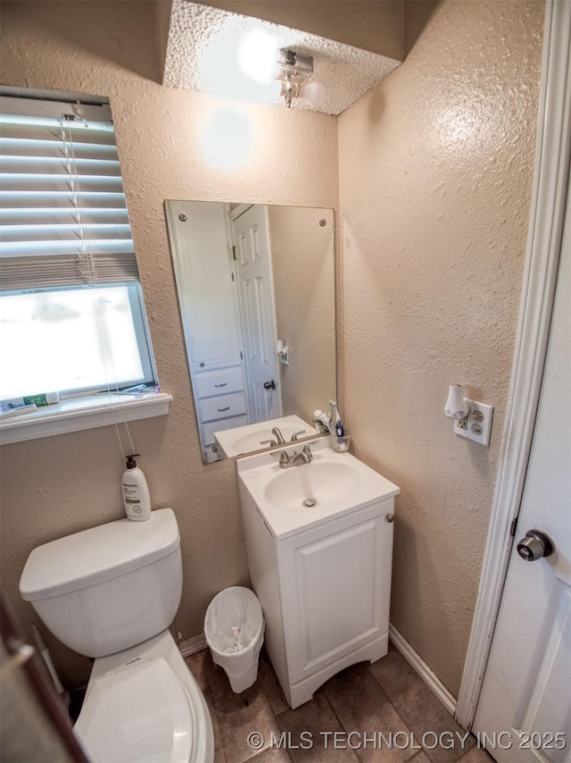 22526 N 2860th Rd, Kingfisher, OK 73750 - half bathroom with tile patterned flooring, toilet, vanity, and a textured wall