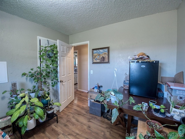 22526 N 2860th Rd, Kingfisher, OK 73750 - office space featuring wood finished floors and a textured ceiling