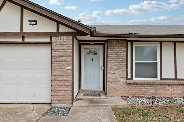 6429 S 30th W Ave, Tulsa, OK 74132 - entrance to property with brick siding, a garage, and a shingled roof