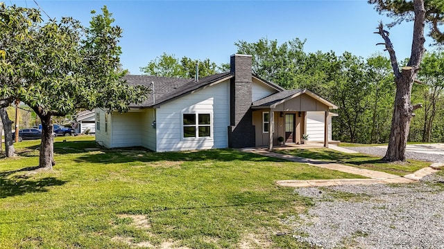 824 Wilson, Durant, OK 74701 - view of front of house featuring a shingled roof, a chimney, and a front lawn