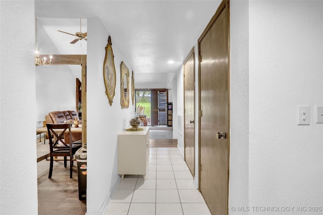 6370 S 29th W Pl, Tulsa, OK 74132 - hall featuring a textured wall, light tile patterned floors, and baseboards