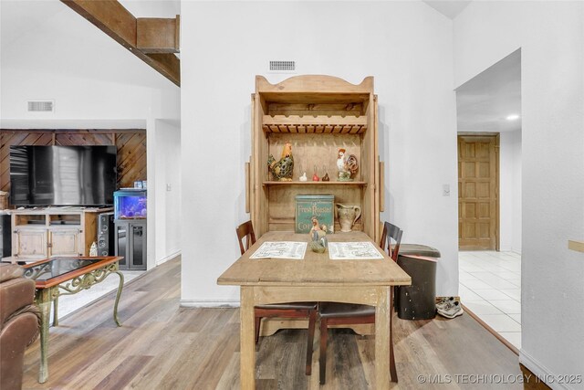6370 S 29th W Pl, Tulsa, OK 74132 - dining space with wood finished floors, high vaulted ceiling, and baseboards