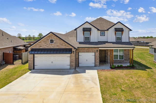view of front facade with a front yard, a shingled roof, board and batten siding, brick siding, and driveway
