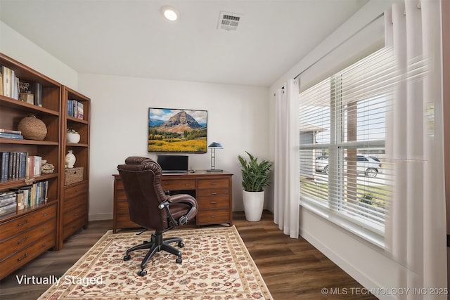 home office featuring baseboards, dark wood-style floors, and visible vents