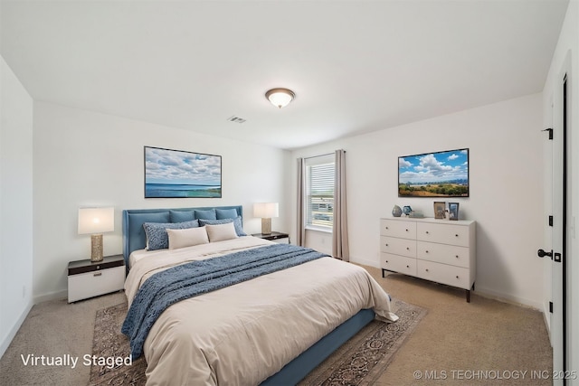carpeted bedroom with visible vents and baseboards