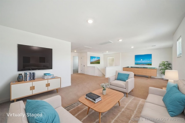 carpeted living room with visible vents, recessed lighting, and attic access