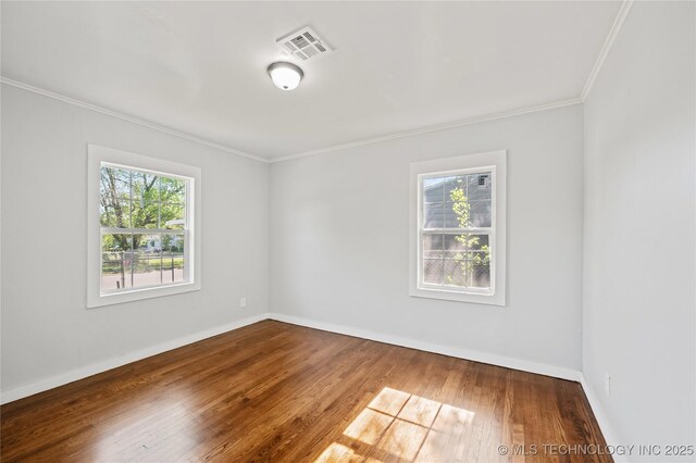920 E 33rd St N, Tulsa, OK 74106 - spare room with crown molding, healthy amount of natural light, hardwood / wood-style floors, and baseboards