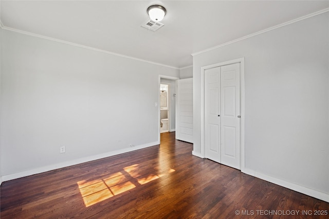 920 E 33rd St N, Tulsa, OK 74106 - unfurnished bedroom featuring wood finished floors, ornamental molding, baseboards, and a closet