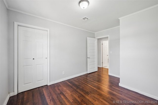 920 E 33rd St N, Tulsa, OK 74106 - unfurnished bedroom featuring wood finished floors, baseboards, crown molding, and a closet
