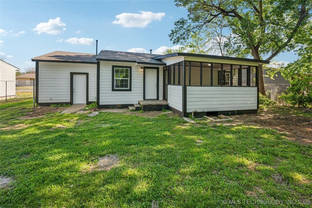 920 E 33rd St N, Tulsa, OK 74106 - back of house featuring a yard and a sunroom