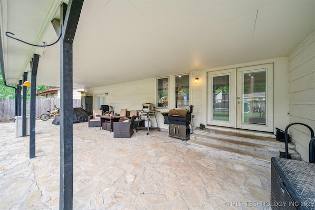 view of patio / terrace with fence, a grill, entry steps, and french doors