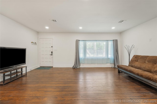 living area with recessed lighting, visible vents, and wood finished floors