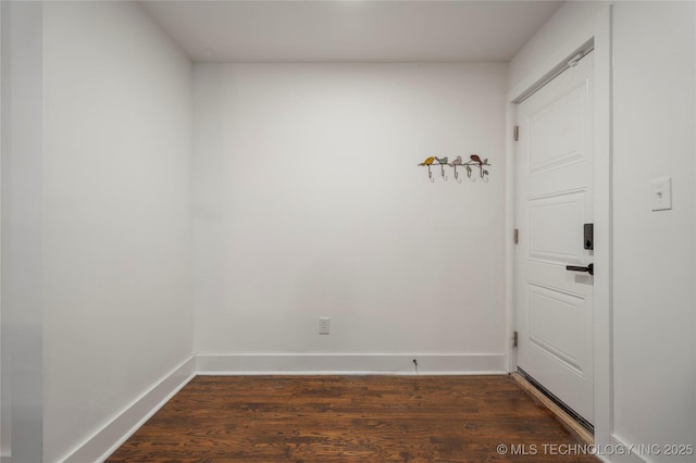empty room with wood finished floors and baseboards