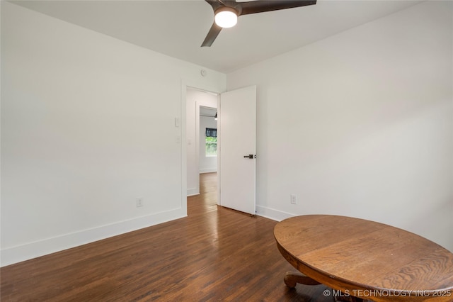 empty room with baseboards, a ceiling fan, and wood finished floors