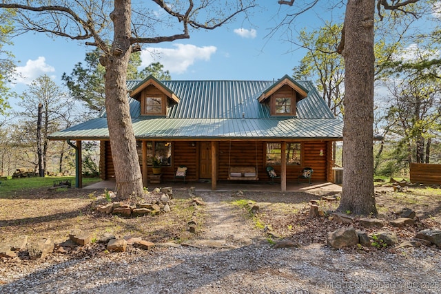14484 Valley View Dr, Skiatook, OK 74070 - log-style house with a porch, a metal roof, and log siding