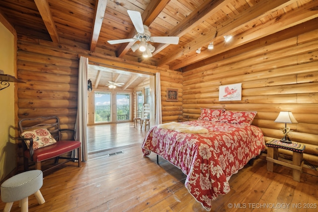 bedroom with rustic walls, visible vents, hardwood / wood-style floors, beam ceiling, and wood ceiling