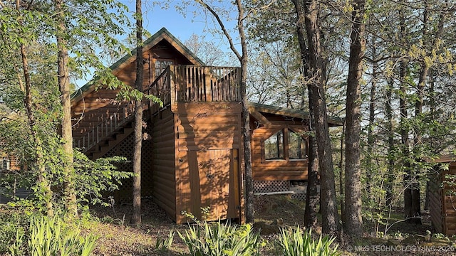 view of side of home featuring log veneer siding