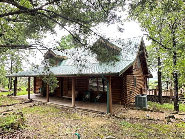 14484 Valley View Dr, Skiatook, OK 74070 - view of side of property featuring log siding, a deck, and a metal roof