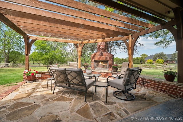 view of patio with a pergola, fence, and an outdoor brick fireplace