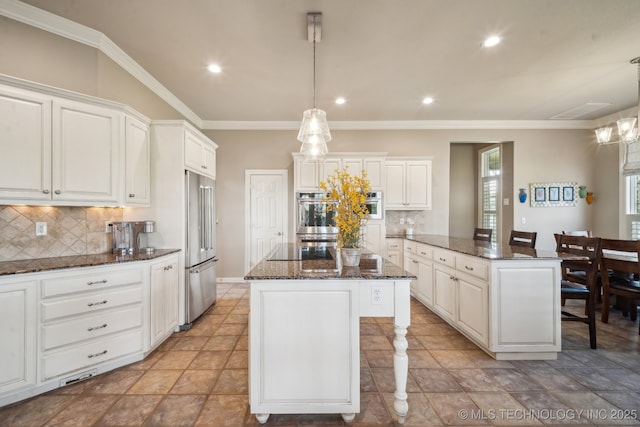 kitchen featuring dark stone countertops, white cabinetry, backsplash, a kitchen island, and stainless steel double oven