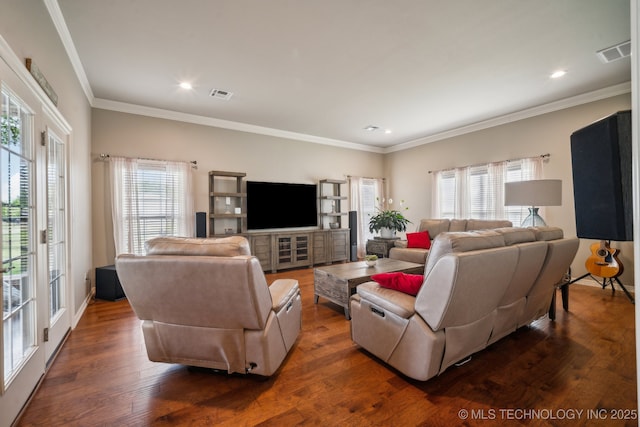 living area featuring visible vents, dark wood-style flooring, and a healthy amount of sunlight