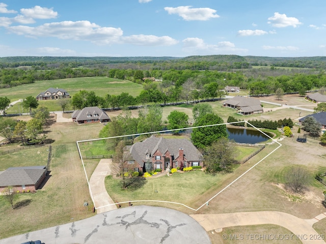 aerial view featuring a wooded view