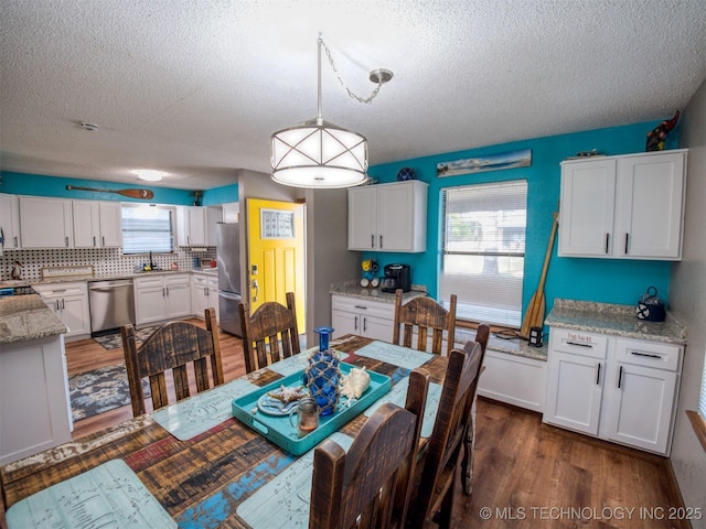 1668 Waters Rd, Kingston, OK 73439 - dining room with dark wood-style floors and a textured ceiling