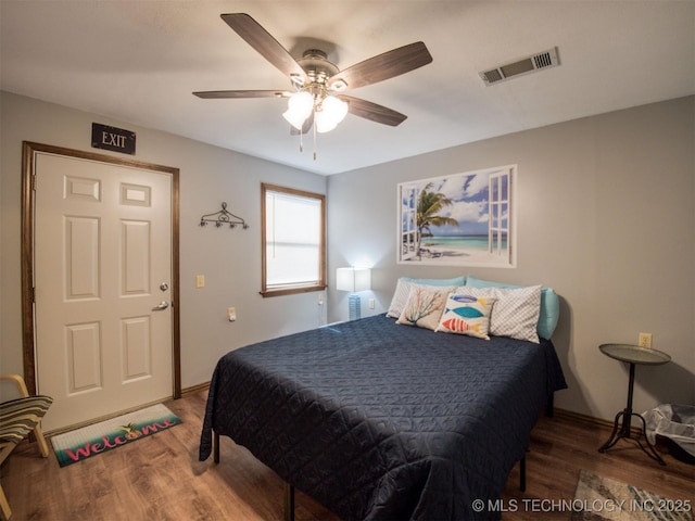 1668 Waters Rd, Kingston, OK 73439 - bedroom featuring visible vents, baseboards, a ceiling fan, and wood finished floors