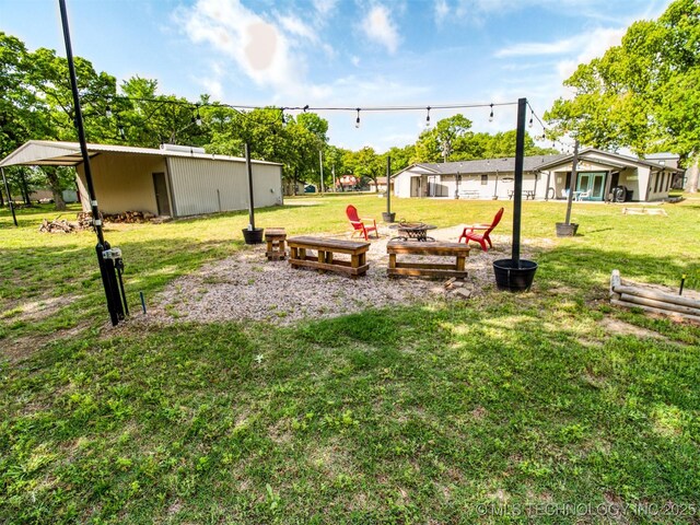 1668 Waters Rd, Kingston, OK 73439 - view of yard featuring a fire pit and an outdoor structure