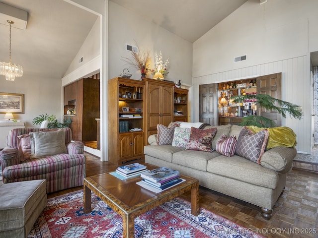 8404 S Toledo Ave, Tulsa, OK 74137 - living room featuring high vaulted ceiling, visible vents, and an inviting chandelier