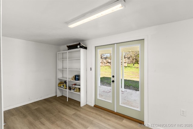 doorway to outside featuring french doors, baseboards, and wood finished floors