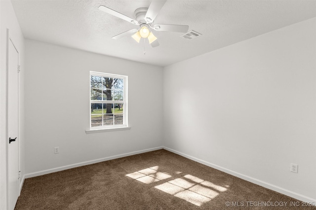 unfurnished room with carpet floors, baseboards, a ceiling fan, and visible vents