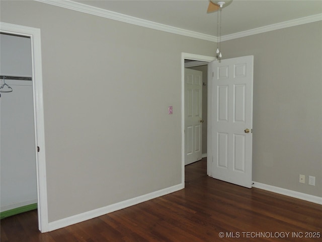906 S 85th E Ave, Tulsa, OK 74112 - unfurnished bedroom featuring baseboards, crown molding, dark wood-style floors, and a closet