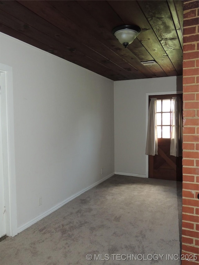 906 S 85th E Ave, Tulsa, OK 74112 - unfurnished room featuring baseboards, carpet, and wood ceiling