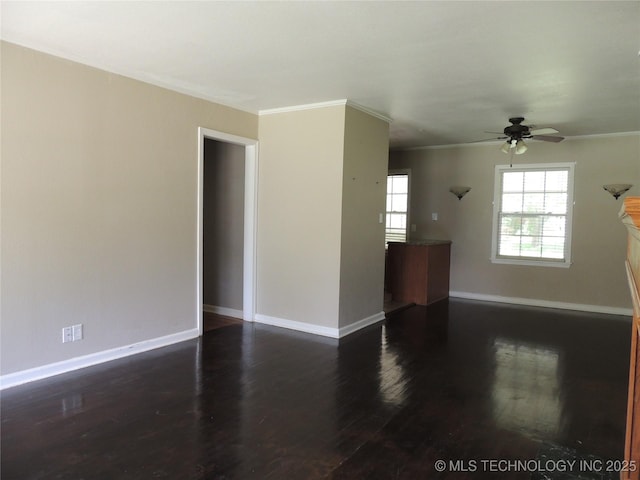 906 S 85th E Ave, Tulsa, OK 74112 - unfurnished living room featuring dark wood-style flooring, ceiling fan, ornamental molding, and baseboards