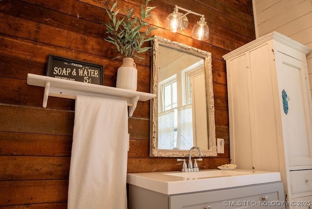 bathroom with wood walls and vanity