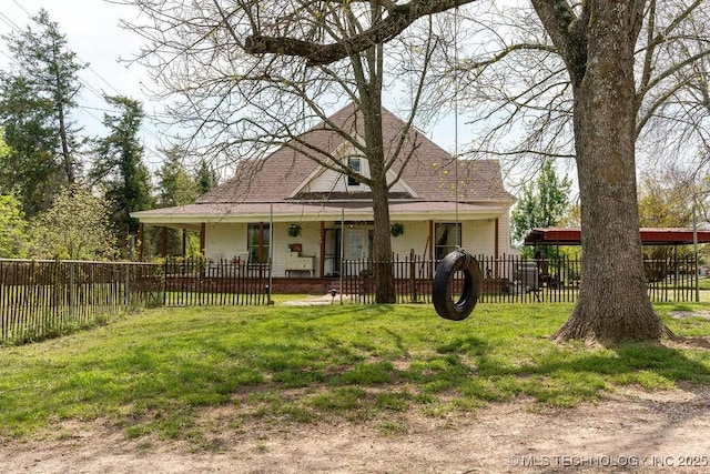 rear view of property with covered porch, a shingled roof, a lawn, and a fenced front yard