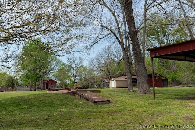 view of yard featuring an outbuilding and a storage unit