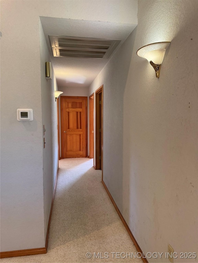 hall featuring light carpet
