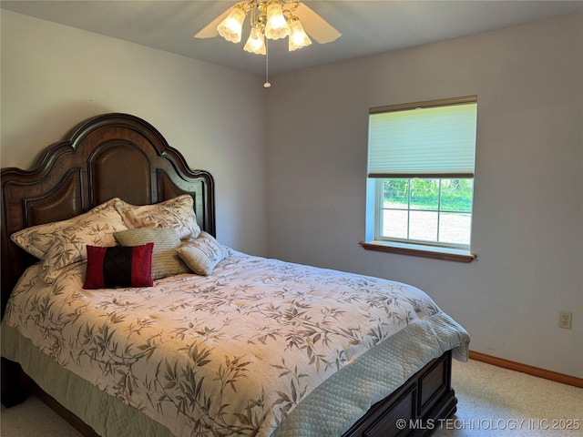 bedroom with light carpet, baseboards, and a ceiling fan