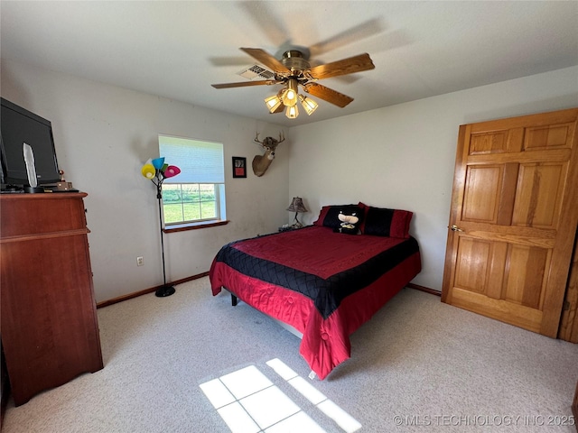 bedroom with carpet floors, baseboards, ceiling fan, and visible vents