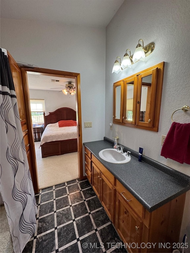 bathroom featuring ensuite bath, tile patterned floors, and vanity