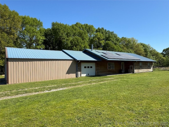 exterior space featuring solar panels and an attached garage